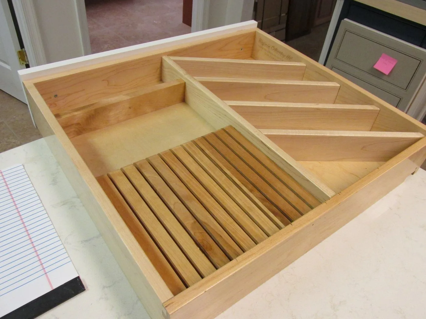 A maple drawer with fitted dividers and a slatted rack