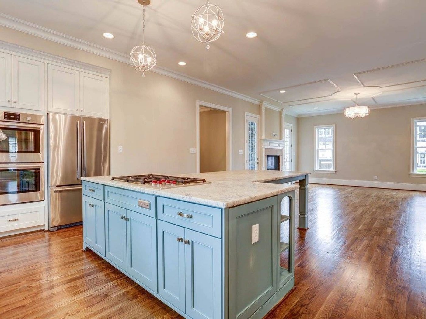 A painted kitchen island with a cooktop and open sightlines