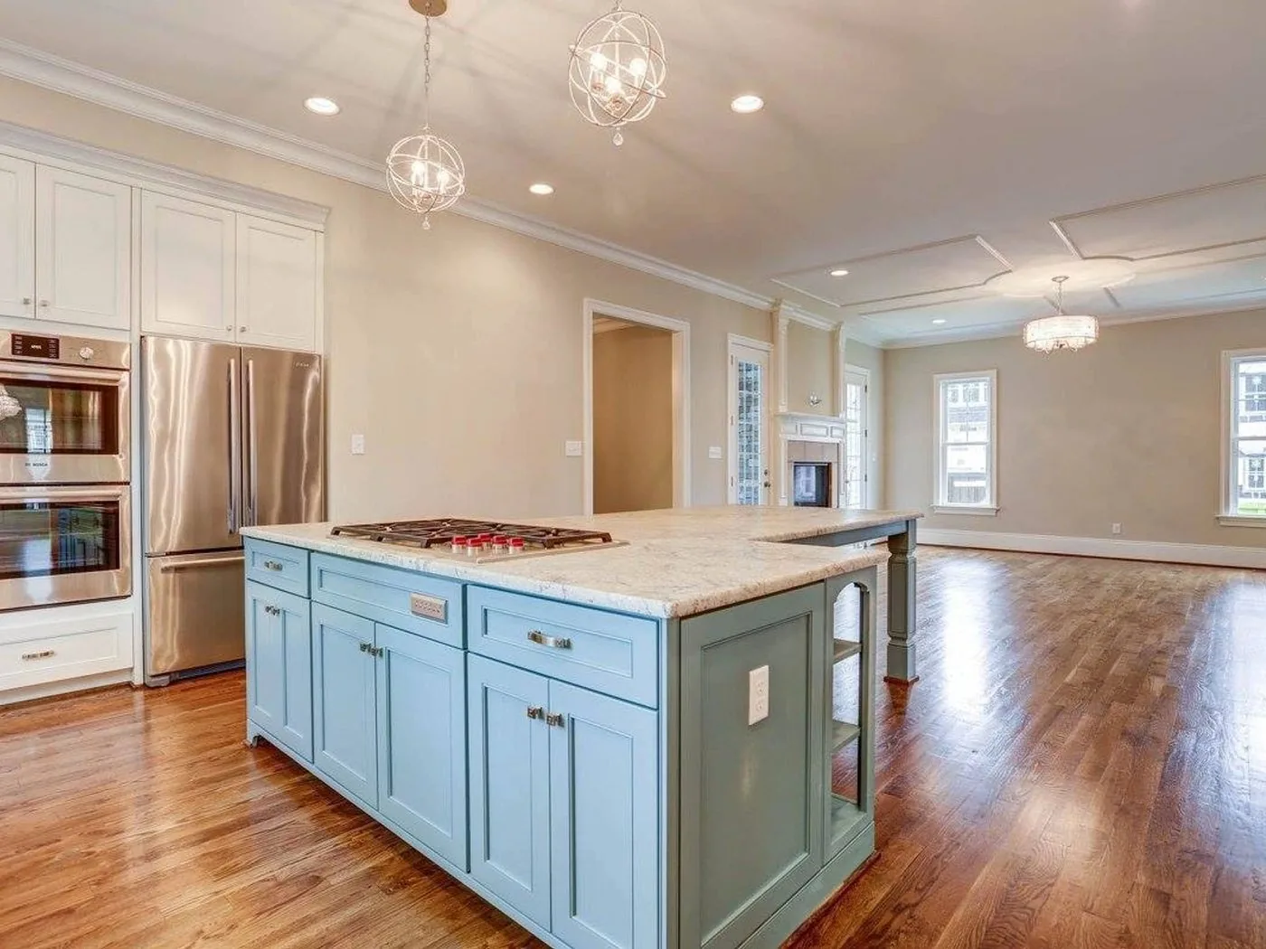 A painted kitchen island with a cooktop and open sightlines