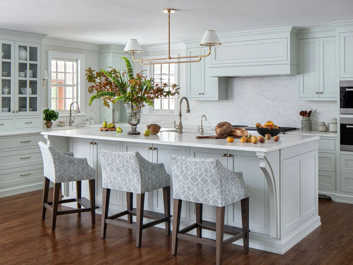 A painted custom kitchen with a marble island