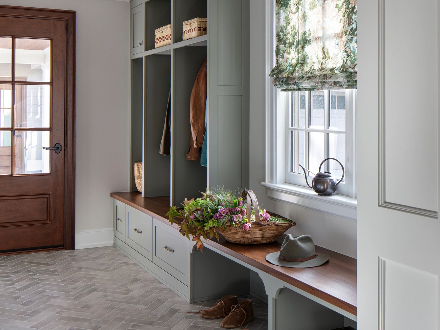 A mudroom with a built-in bench, cubbies and hooks
