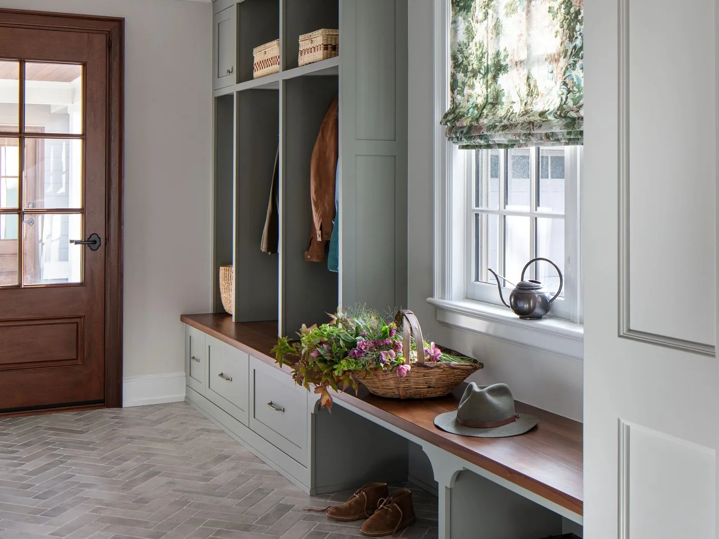 A mudroom with a built-in bench, cubbies and hooks