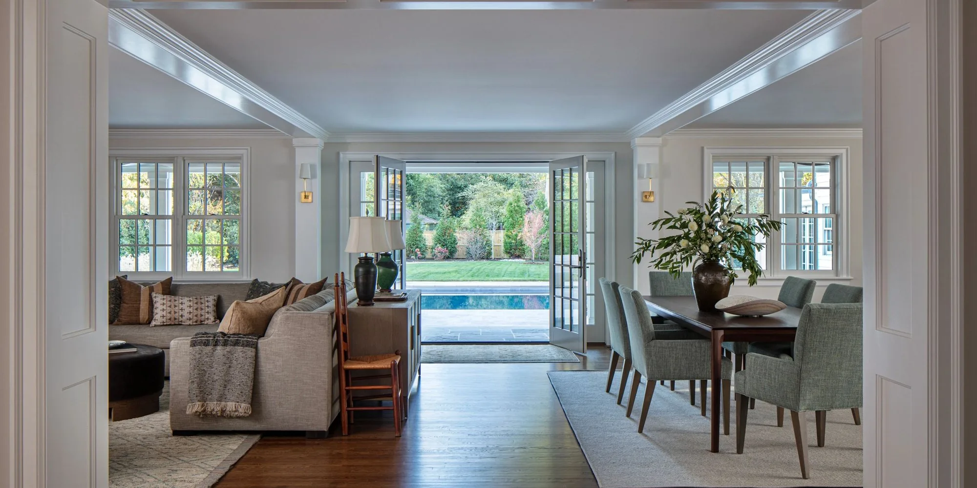 An open plan room with custom built-in cabinetry looking through to the garden